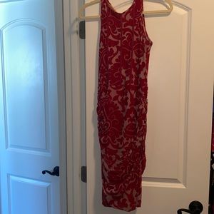 Beautiful red and tan fitted dress. Gathered on both sides, knee link, size XS